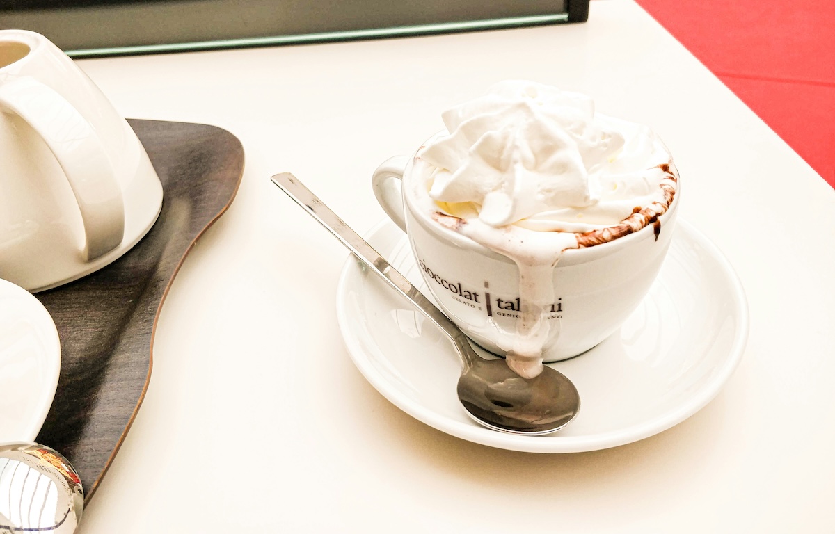 Luxurious hot chocolate with whipped cream in a café setting